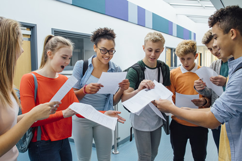 A group of people is checking their results and discussing their achievements.