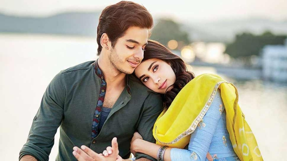 A scene from the movie Dhadak where Jhanvi Kapoor (Actor) and Ishaan Khattar (Actor) are seen sitting together sharing a hug.