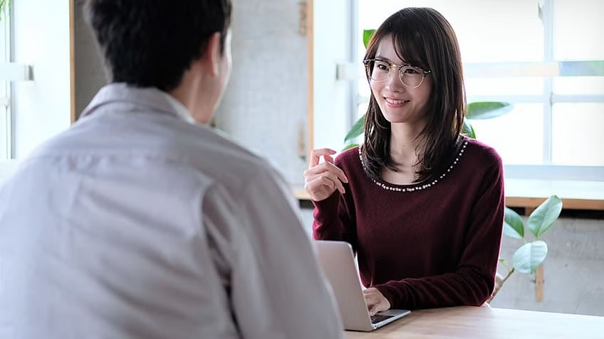 An image describes two people having a positive discussion.