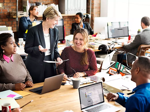 The picture shows a group of individuals in a business meeting setting.