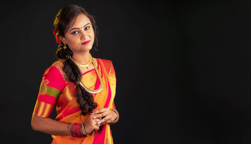 A lady wearing a silk saree posing for a Photograph for a Matrimonial Profile Picture image