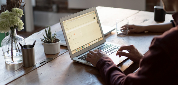 A person working on his laptop in an office setup image