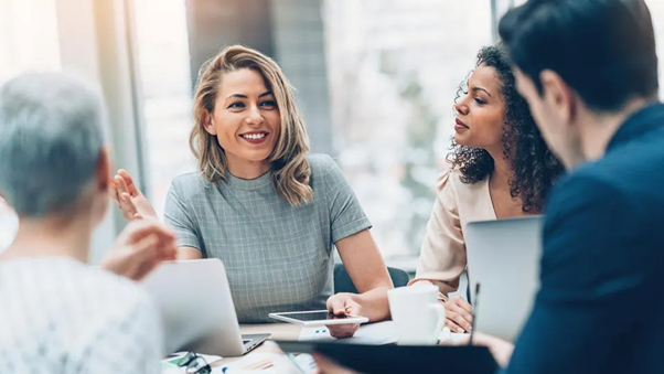 Four people having a team conversation in an office image